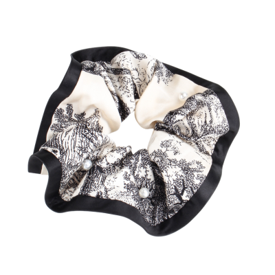 Patterned satin scrunchie, fashionable women's hair tie, hair accessory for tying ponytails.